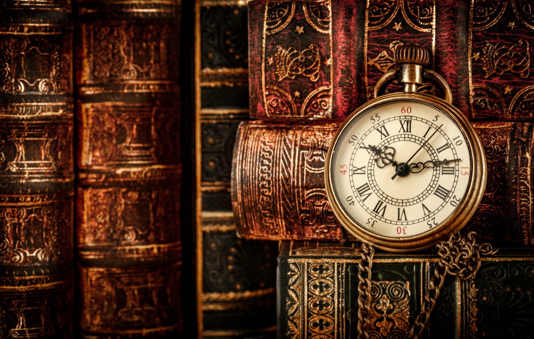 Vintage pocket watch on an antique book
